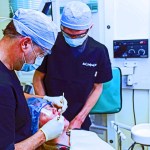 Two staff members taking care of a patient